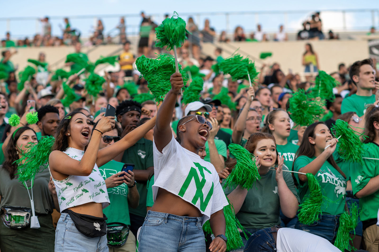 Students cheering on the UNT football team. 