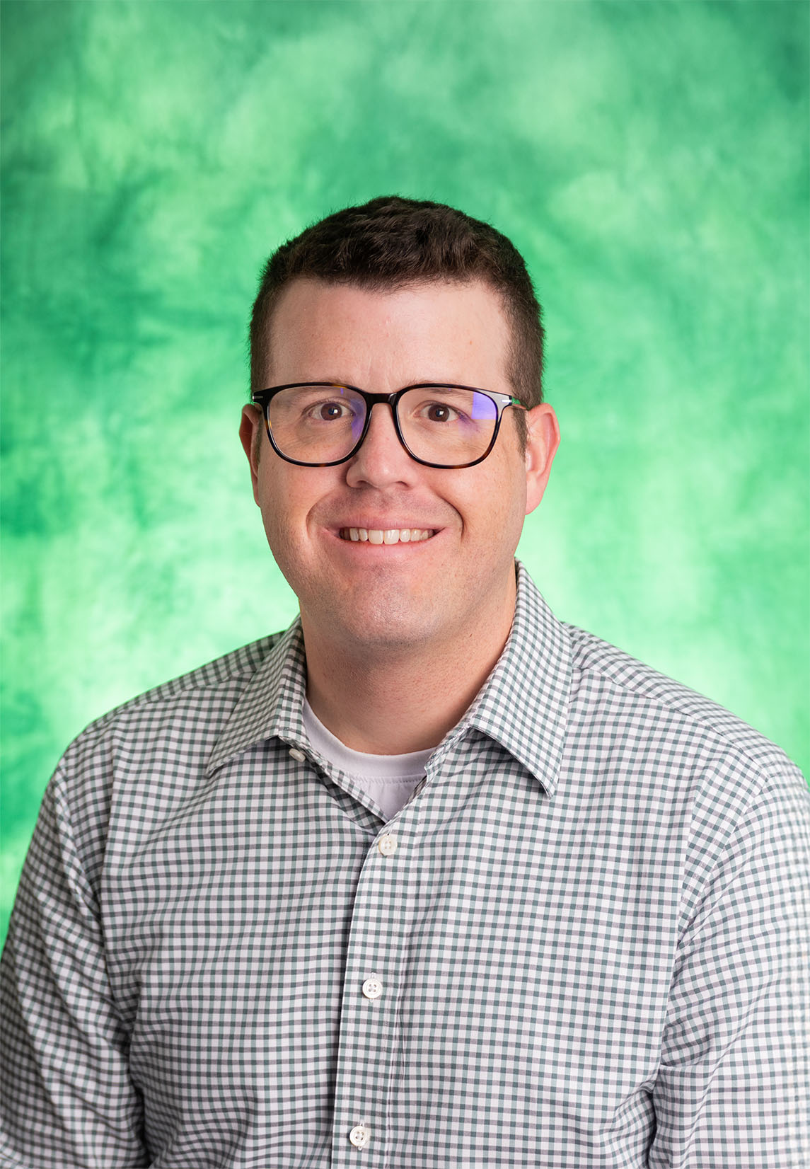 Man wearing glasses and a button up shirt.